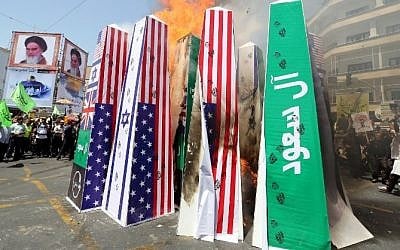 Iranian protesters burn Israeli, US and Saudi Arabian flags during a demonstration to mark the Quds (Jerusalem) International day in Tehran on July 10, 2015. (AFP/ ATTA KENARE) Iranian protesters burn Israeli, US and Saudi Arabian flags during a demonstration to mark the Quds (Jerusalem) International day in Tehran on July 10, 2015. (AFP/ ATTA KENARE)