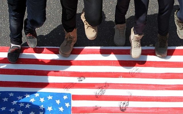 Iraqi men step on a US flag during a demonstration marking the Quds (Jerusalem) International day in the capital Baghdad, on July 10, 2015. (AFP/ AHMAD AL-RUBAYE) Iraqi men step on a US flag during a demonstration marking the Quds (Jerusalem) International day in the capital Baghdad, on July 10, 2015. (AFP/ AHMAD AL-RUBAYE)