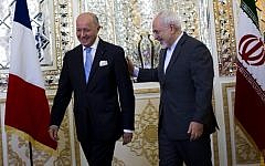 Iranian Foreign Minister Mohammad Javad Zarif (R) greets his French counterpart Laurent Fabius prior to their talks in Tehran on July 29, 2015. Iranian President Hassan Rouhani visits France during the last week of January 2016. (Behrouz Mehri/AFP)