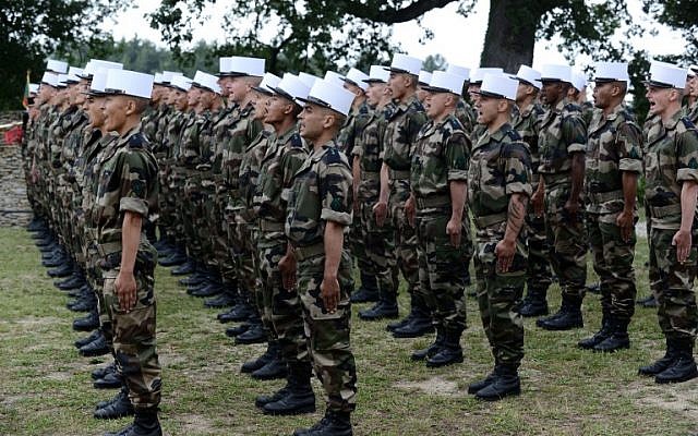 Soldiers of the French Foreign Legion receive their White Kepi during a ceremony at 'The Farm,' a training center near Castelnaudary, southwestern France, June 16, 2015. (AFP PHOTO / REMY GABALDA) Soldiers of the French Foreign Legion receive their White Kepi during a ceremony at 'The Farm,' a training center near Castelnaudary, southwestern France, June 16, 2015. (AFP PHOTO / REMY GABALDA)