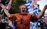 A man celebrates at Klafthmonos Square in Athens on July 5, 2015 after the first exit-polls of the Greek referendum.
(AFP/IAKOVOS HATZISTAROU)