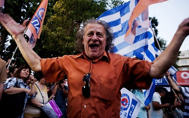 A man celebrates at Klafthmonos Square in Athens on July 5, 2015 after the first exit-polls of the Greek referendum.
(AFP/IAKOVOS HATZISTAROU) A man celebrates at Klafthmonos Square in Athens on July 5, 2015 after the first exit-polls of the Greek referendum.
(AFP/IAKOVOS HATZISTAROU)