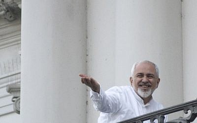 Iranian Foreign Minister Mohammad Javad Zarif gestures toward reporters as he talks with Iranian Deputy Foreign Minister, Iranian deputy foreign minister for European and American Affairs, and the brother of the Iranian president (not pictured) onto a balcony of the Palais Coburg Hotel, where the Iran nuclear talks meetings are being held in Vienna on July 11, 2015 (AFP PHOTO / JOE KLAMAR) Iranian Foreign Minister Mohammad Javad Zarif gestures toward reporters as he talks with Iranian Deputy Foreign Minister, Iranian deputy foreign minister for European and American Affairs, and the brother of the Iranian president (not pictured) onto a balcony of the Palais Coburg Hotel, where the Iran nuclear talks meetings are being held in Vienna on July 11, 2015 (AFP PHOTO / JOE KLAMAR)