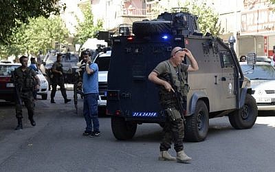 Turkish police officers check the area after an attack against Turkish police officers in the center of Diyarbakir on July 23, 2015. A Turkish police officer was shot dead and a second one wounded today in the mainly Kurdish city of Diyarbakir in the latest in a series of attacks that began with a suicide bombing blamed on the Islamic State, security sources said. (Ilyas Akengin/AFP)