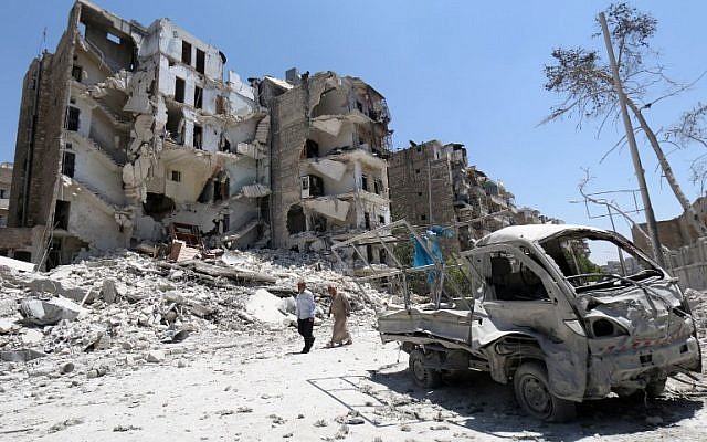 Syrian men walk amidst the rubble and debris in the northern Syrian city of Aleppo on July 5, 2015. Two alliances of Syrian rebels battled to advance in government-held western Aleppo, seizing an army barracks in one district but losing ground in others, in some of the fiercest fighting in the city since the conflict began. AFP PHOTO / AMC / ZEIN AL-RIFAI Syrian men walk amidst the rubble and debris in the northern Syrian city of Aleppo on July 5, 2015. Two alliances of Syrian rebels battled to advance in government-held western Aleppo, seizing an army barracks in one district but losing ground in others, in some of the fiercest fighting in the city since the conflict began. AFP PHOTO / AMC / ZEIN AL-RIFAI