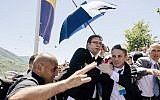 Bodyguards try to protect Serbian Prime Minister Aleksandar Vucic (C) from stones hurled at him by an angry crowd at the Potocari Memorial Center, near the eastern Bosnian town of Srebrenica on July 11, 2015. (AFP PHOTO / DIMITAR DILKOFF)