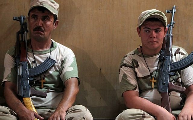 Iraqi Christian volunteer fighters from Baghdad and the northern embattled Mosul governorate attend a training session at a base in Baghdad airport on July 1, 2015, after joining the Popular Mobilization units in the combat against Islamic State (IS) group fighters. (AFP PHOTO / AHMAD AL-RUBAYE)