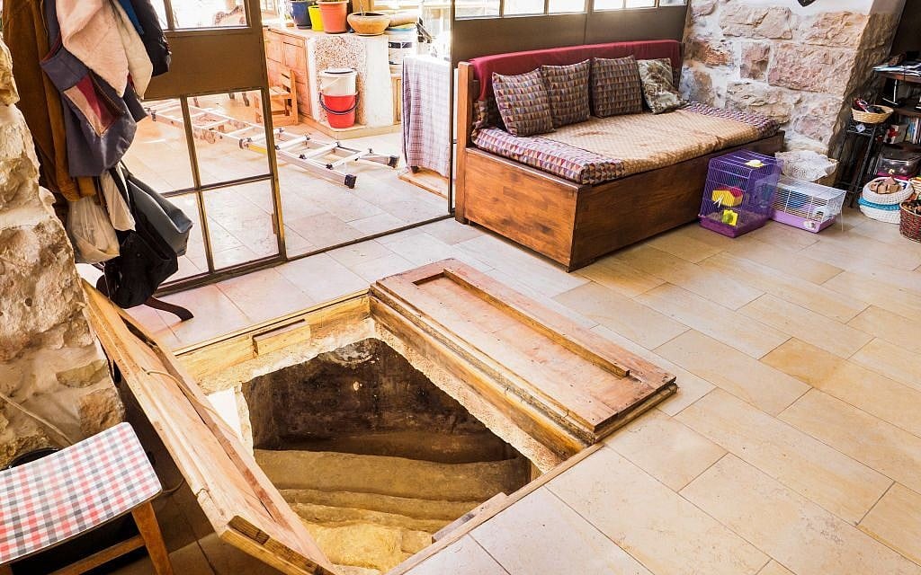 A trap door in the Shimshoni's living room opening up to a ancient ritual bath. (Assaf Peretz/courtesy Israel Antiquities Authority) A trap door in the Shimshoni's living room opening up to a ancient ritual bath. (Assaf Peretz/courtesy Israel Antiquities Authority)