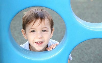 Oren loves riding his bike, wearing hats and playing ball. He has polymicrogyria, which affects the development of his brain (Rick Guidotti)