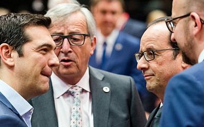 Greek Prime Minister Alexis Tsipras, left, speaks with, from left, European Commission President Jean-Claude Juncker, French President Francois Hollande and Belgian Prime Minister Charles Michel during a meeting of eurozone heads of state at the EU Council building in Brussels on Sunday, July 12, 2015. (AP/Geert Vanden Wijngaert)