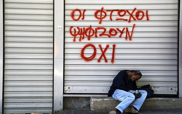 A man sleeps, holding an icon of Jesus Christ, outside a closed shop with spray paint reading "Poor vote "NO" in central Athens, on Saturday, July 4, 2015. (AP/Petros Karadjias) A man sleeps, holding an icon of Jesus Christ, outside a closed shop with spray paint reading "Poor vote "NO" in central Athens, on Saturday, July 4, 2015. (AP/Petros Karadjias)
