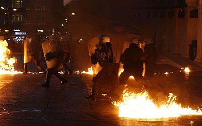 Riot police try to avoid petrol bombs during clashes in Athens, Wednesday, July 15, 2015. (AP/Emilio Morenatti)