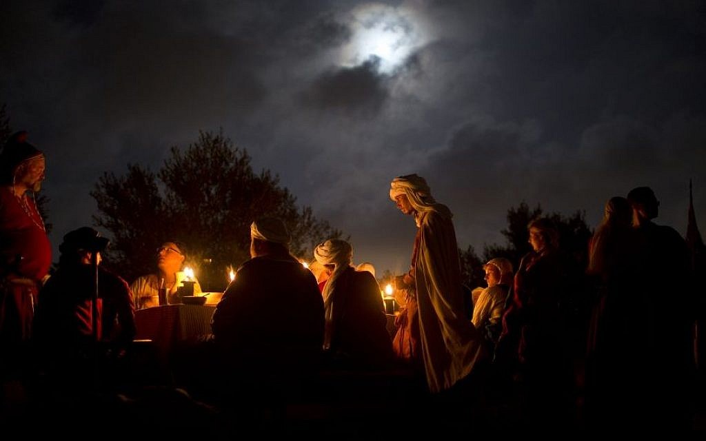 Israeli and Russian members of knight clubs wearing medieval costumes eat dinner two nights before marching 27 kilometers (17 miles) to the reenactment of the Battle of Hattin, from the ancient Israeli city of Zippori to Horns of Hattin, northern Israel, July 2, 2015 (AP/Oded Balilty)