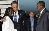 Kenyan President Uhuru Kenyatta, right, watches as President Barack Obama, center, hugs his half-sister Auma Obama, after he arrived at Kenyatta International Airport, on Friday, July 24, 2015, in Nairobi, Kenya (AP Photo/Evan Vucci)