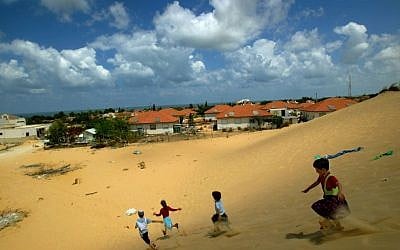 Israeli children play on a sand dune overlooking their homes in the Jewish settlement of Neve Dekalim, in the Gush Katif bloc  in the southern Gaza Strip, Monday, Aug. 8, 2005. N (AP Photo/David Guttenfelder)
