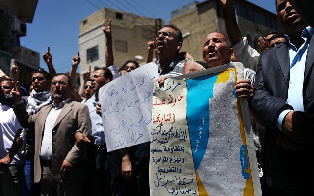 Protesters chant slogans against Israel to condemn its bombing of Gaza and demanding Hamas and other Palestinian brigades in Gaza reject any truce with Israel, during a protest by followers of the Muslim Brotherhood in Amman, Jordan, Friday, July 18, 2014 (AP/Mohammad Hannon)
