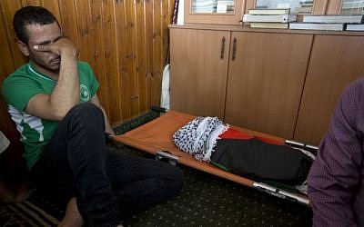 A Palestinian man mourns alongside the body of a one-and-a-half year old boy, Ali Dawabsha, during his funeral in Duma village near the West Bank city of Nablus, Friday, July 31, 2015. (Majdi Mohammed/AP) A Palestinian man mourns alongside the body of a one-and-a-half year old boy, Ali Dawabsha, during his funeral in Duma village near the West Bank city of Nablus, Friday, July 31, 2015. (Majdi Mohammed/AP)