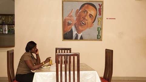 In this picture taken on Saturday, July 4, 2015, a woman sits in the restaurant of  a hotel named after US President Barack Obama in Accra, Ghana (AP Photo/Christian Thompson)