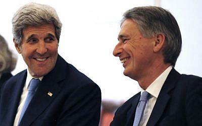 US Secretary of State John Kerry, left, talks with British Foreign Secretary Philip Hammond, right, as they meet with foreign ministers from China, Germany and France at an hotel in Vienna, Austria Monday, July 6, 2015. (Carlos Barria/Pool Photo via AP)