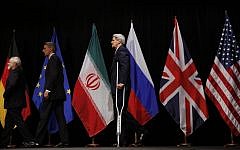 US Secretary of State John Kerry, right, British Foreign Secretary Philip Hammond, center, and Iranian Foreign Minister Mohammad Javad Zarif, left, leave the stage after a group picture at the Vienna International Center in Vienna, Austria Tuesday July 14, 2015.  (Carlos Barria, Pool Photo via AP)