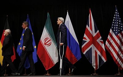 US Secretary of State John Kerry, right, British Foreign Secretary Philip Hammond, center, and Iranian Foreign Minister Mohammad Javad Zarif, left, leave the stage after a group picture at the Vienna International Center in Vienna, Austria Tuesday July 14, 2015.  (Carlos Barria, Pool Photo via AP)