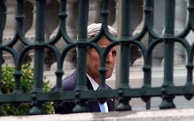 US Secretary of State John Kerry walks in the garden of Coburg where closed-door nuclear talks with Iran take place in Vienna, Austria, Sunday July 12, 2015. (AP/Ronald Zak) 