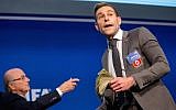 Comedian Simon Brodkin prepares to attack FIFA President Joseph S. Blatter (R) with money during a press conference at the Extraordinary FIFA Executive Committee Meeting at the FIFA headquarters on July 20, 2015 in Zurich, Switzerland. (JTA/Philipp Schmidli/Getty Images)