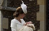 Britain's Kate the Duchess of Cambridge carries Princess Charlotte after taking her out of a pram as they arrive for Charlotte's Christening at St. Mary Magdalene Church in Sandringham, England, Sunday, July 5, 2015. (AP/Matt Dunham, Pool)