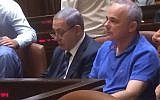 Likud's Yuval Steinitz. in casual dress, sitting next to Prime Minister Benjamin Netanyahu at the Knesset late Monday night, in a photo tweeted by Zionist Union MK Shelly Yacimovich. (Screen capture Twitter)