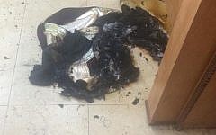 The curtain from an ark in a central Jerusalem synagogue is burned in an arson attack (Courtesy)