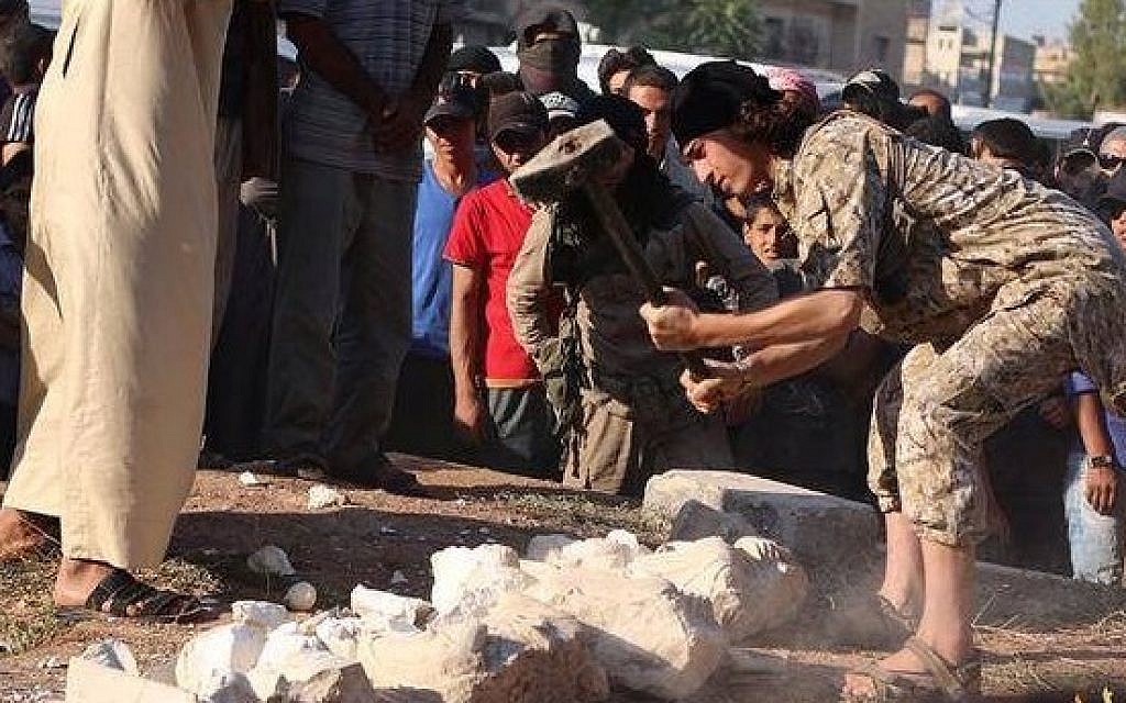 An Islamic State operative smashing statues in the Syrian city of Palmyra, July 2, 2015. (screen capture)