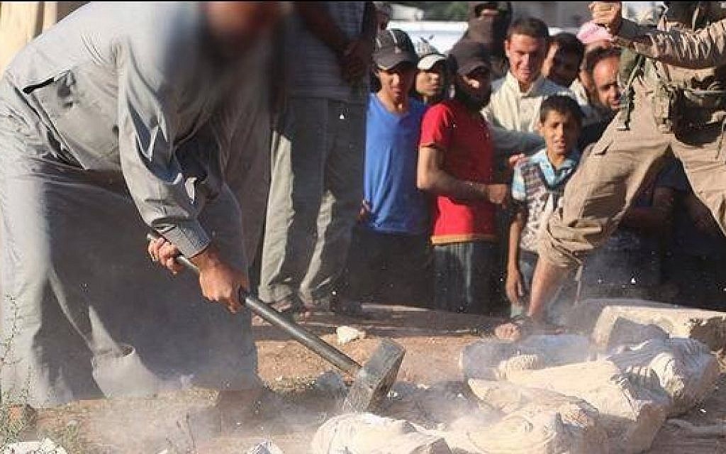 Image of an Islamic State operative smashing statues in the Syrian city of Palmyra, July 2, 2015. (screen capture)