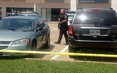 Authorities work an active shooting scene on amincola highway near the Naval Reserve Center, in Chattanooga, Tenn. on  July 16, 2015. (WRCB-TV via AP)