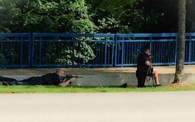 Authorities work an active shooting scene on amincola highway near the Naval Reserve Center, in Chattanooga, Tenn. on  July 16, 2015. (WRCB-TV via AP)