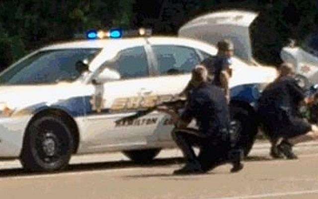 Authorities work an active shooting scene on amincola highway near the Naval Reserve Center, in Chattanooga, Tenn. on July 16, 2015. (WRCB-TV via AP) Authorities work an active shooting scene on amincola highway near the Naval Reserve Center, in Chattanooga, Tenn. on July 16, 2015. (WRCB-TV via AP)