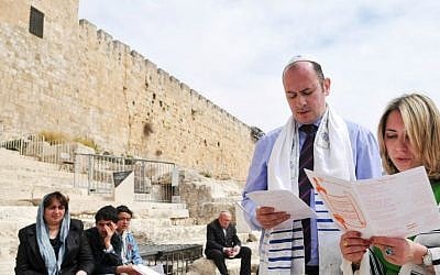 A Reform Jewish couple pray during a bat mitzva ceremony near the Western Wall while wearing tefillin, March 19, 2009. (Yossi Zeliger/FLASH90)