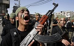 Palestinian students take part in a military march organized by Hamas in the town of Rafah in the southern Gaza Strip, February 27, 2014. (Abed Rahim Khatib/Flash90)