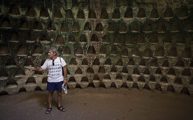 A tourist visits a cave with columbaria at Beit Guvrin, June 22, 2014. (Yonatan Sindel/Flash90)