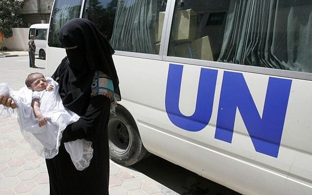 A Palestinian woman holds her baby in an UNRWA center in the Rafah refugee camp, in southern Gaza Strip on August 13, 2014. (Abed Rahim Khatib/Flash90) A Palestinian woman holds her baby in an UNRWA center in the Rafah refugee camp, in southern Gaza Strip on August 13, 2014. (Abed Rahim Khatib/Flash90)