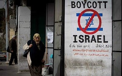 A Palestinian woman walks by a sign calling to boycott Israel in the West Bank city of Bethlehem on February 11, 2015. (Miriam Alster/Flash 90) A Palestinian woman walks by a sign calling to boycott Israel in the West Bank city of Bethlehem on February 11, 2015. (Miriam Alster/Flash 90)