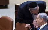 Prime Minister Benjamin Netanyahu speaks with Shas leader and then-economy minister Aryeh Deri in the Knesset on June 17, 2015. (Miriam Alster/Flash90)