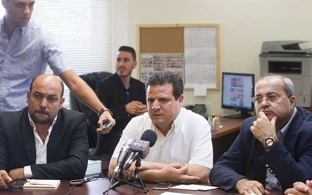 Joint (Arab) List leader MK Ayman Odeh is flanked by MKs Masud Ganaim (L) and Ahmad Tibi at the party's weekly meeting at the Knesset in Jerusalem on June 29, 2015 (Miriam Alster/Flash90)