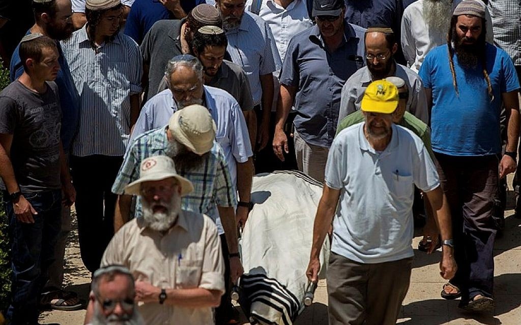 Family and friends carry the body of Malachy Moshe Rosenfeld, 25, during his funeral at Kochav Hashahar in the West Bank, on July 01, 2015. (Yonatan Sindel/Flash90)
