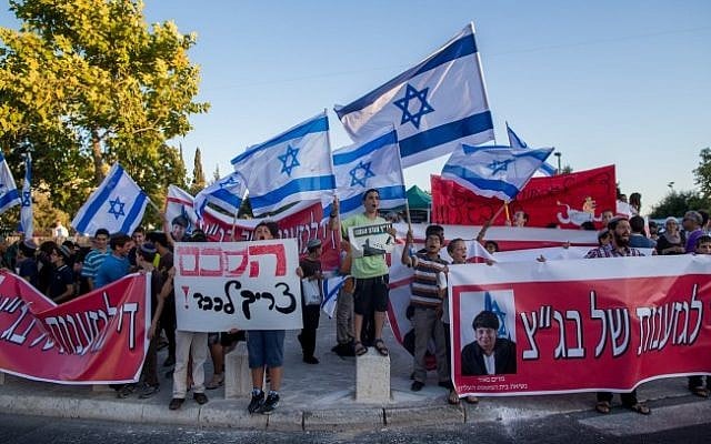 Right-wing activists take part in a protest outside the Supreme Court in Jerusalem on July 8, 2015, calling to cancel the plan to demolish the Dreinoff neighborhood at the Beit El settlement. (Yonatan Sindel/FLASH90) Right-wing activists take part in a protest outside the Supreme Court in Jerusalem on July 8, 2015, calling to cancel the plan to demolish the Dreinoff neighborhood at the Beit El settlement. (Yonatan Sindel/FLASH90)