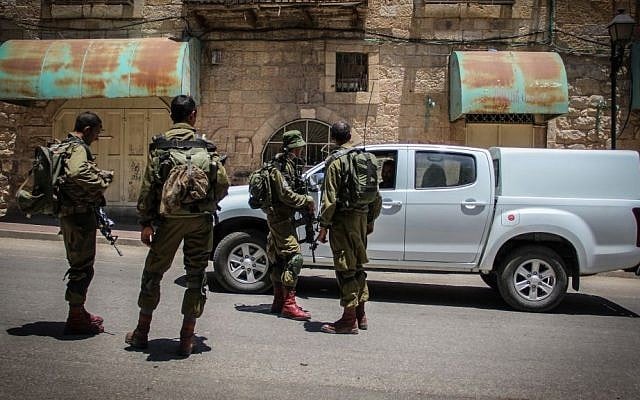 Israeli soldiers in the West Bank city of Hebron, on July 10, 2015. (Garrett Mills/Flash90) Israeli soldiers in the West Bank city of Hebron, on July 10, 2015. (Garrett Mills/Flash90)