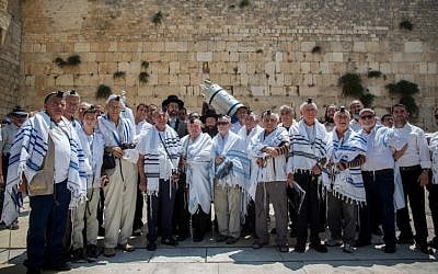 Holocaust survivors pose for a picture after celebrating their belated bar mitzvah at the Western Wall, Judaism's holiest site, in Jerusalem's Old City on July 13, 2015. (Yonatan Sindel/Flash90)