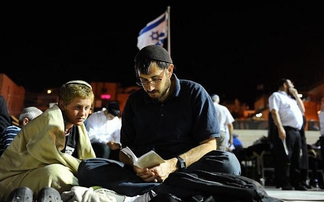 Jewish men praying during the fast of Tisha B'Av at the Western Wall in the Old City of Jerusalem, July 25, 2015. (Mendy Hechtman/Flash90) Jewish men praying during the fast of Tisha B'Av at the Western Wall in the Old City of Jerusalem, July 25, 2015. (Mendy Hechtman/Flash90)
