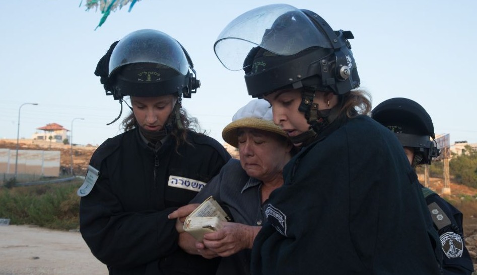 Israeli security forces remove a Jewish settler who came to demonstrate against the demolition of two apartment blocks at the Jewish settlement of Beit El, on July 28, 2015 (Photo by Nati Shohat/FLASH90) Israeli security forces remove a Jewish settler who came to demonstrate against the demolition of two apartment blocks at the Jewish settlement of Beit El, on July 28, 2015 (Photo by Nati Shohat/FLASH90)