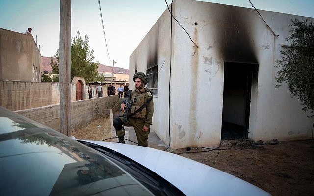 An Israeli soldier stands near a house in the Palestinian village of Duma, near Nablus, where a Palestinian infant was killed July 31, 2015, in an arson attack, apparently by Jewish extremists. (Photo by FLASH90) An Israeli soldier stands near a house in the Palestinian village of Duma, near Nablus, where a Palestinian infant was killed July 31, 2015, in an arson attack, apparently by Jewish extremists. (Photo by FLASH90)