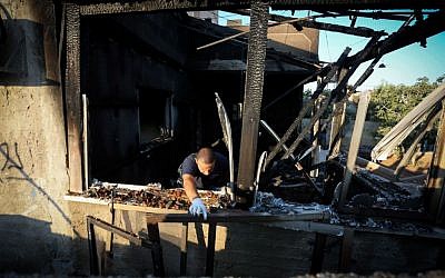 Israeli security forces seen at a house in the Palestinian village of Duma, near Nablus, where a Palestinian infant was killed July 31, 2015, in an arson attack, apparently by Jewish extremists. Two homes in Duma, were set on fire, and the Hebrew words “revenge” and “long live king messiah” were spray-painted on their walls, alongside a Star of David. (Photo by FLASH90)